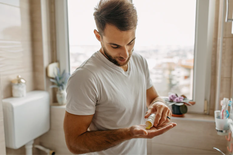 Man takes a zinc tablet in his bathroom