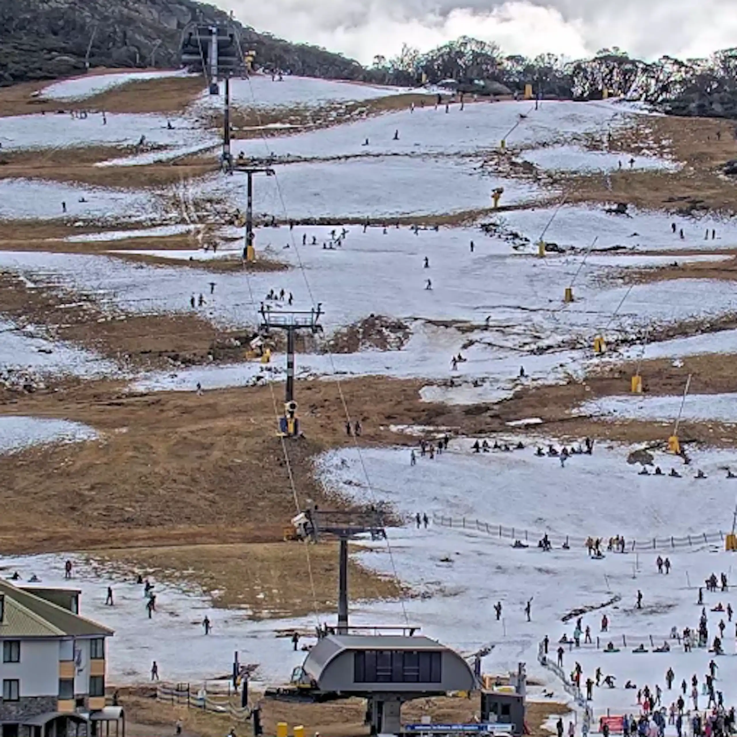 A pic of a ski run shows sparse snow and lots of clear ground.