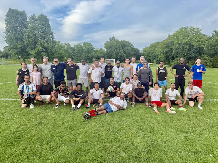 A group of grassroots soccer players posing for a photograph.