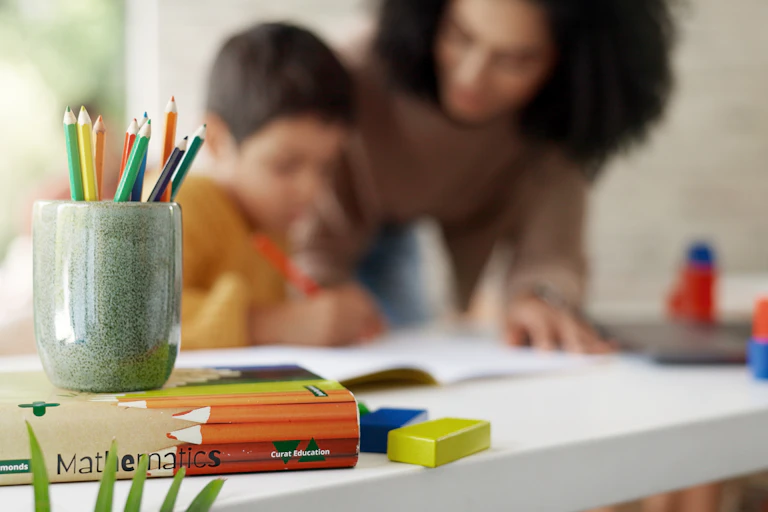 A mother helping her son study at home.