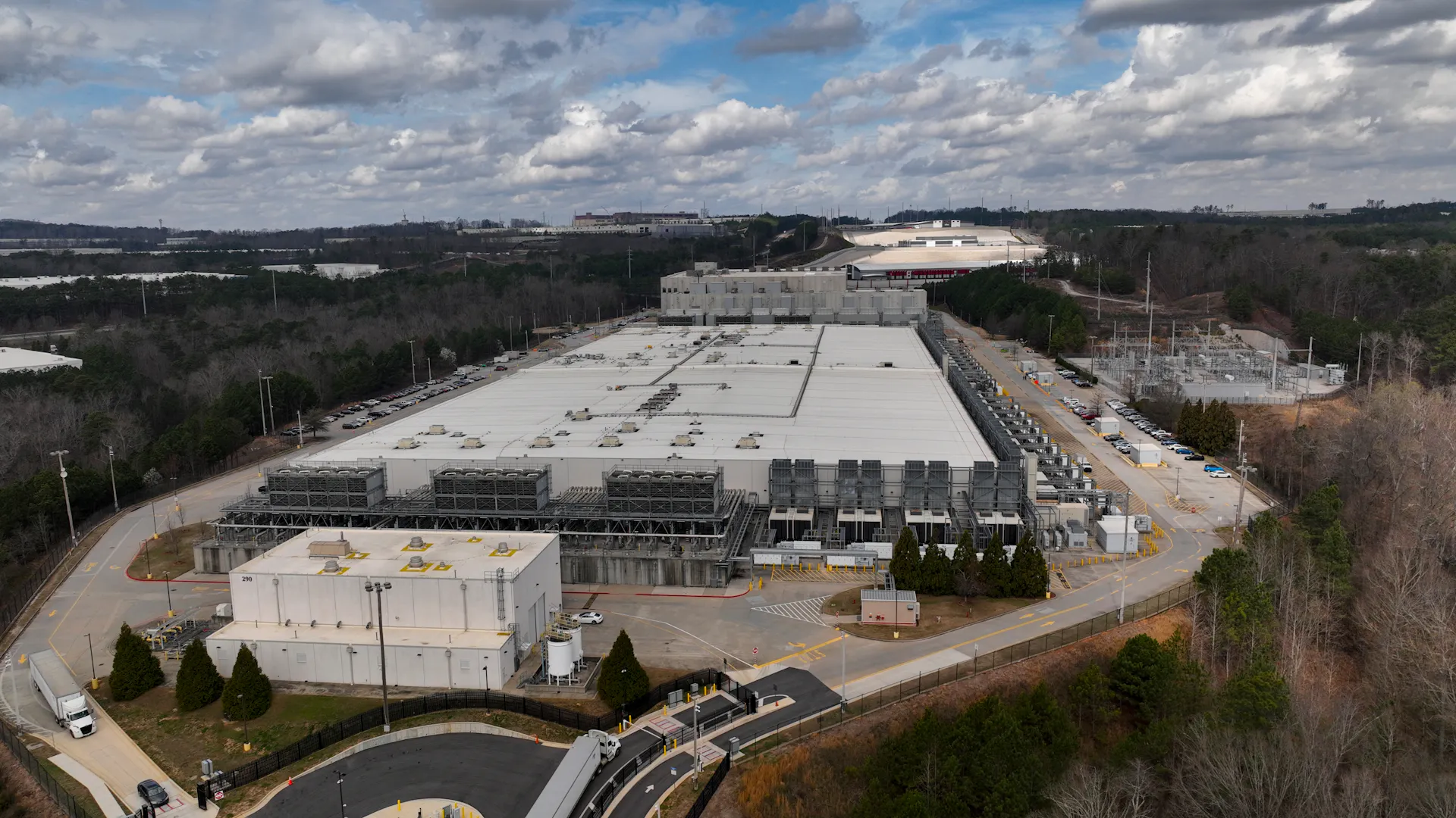 An aerial view shows a large flat building.