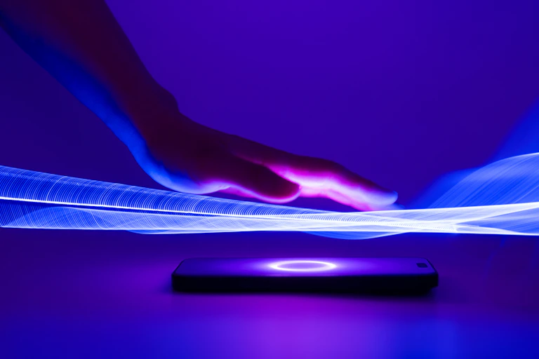 Digital illustration of a hand hovering over a glowing screen.