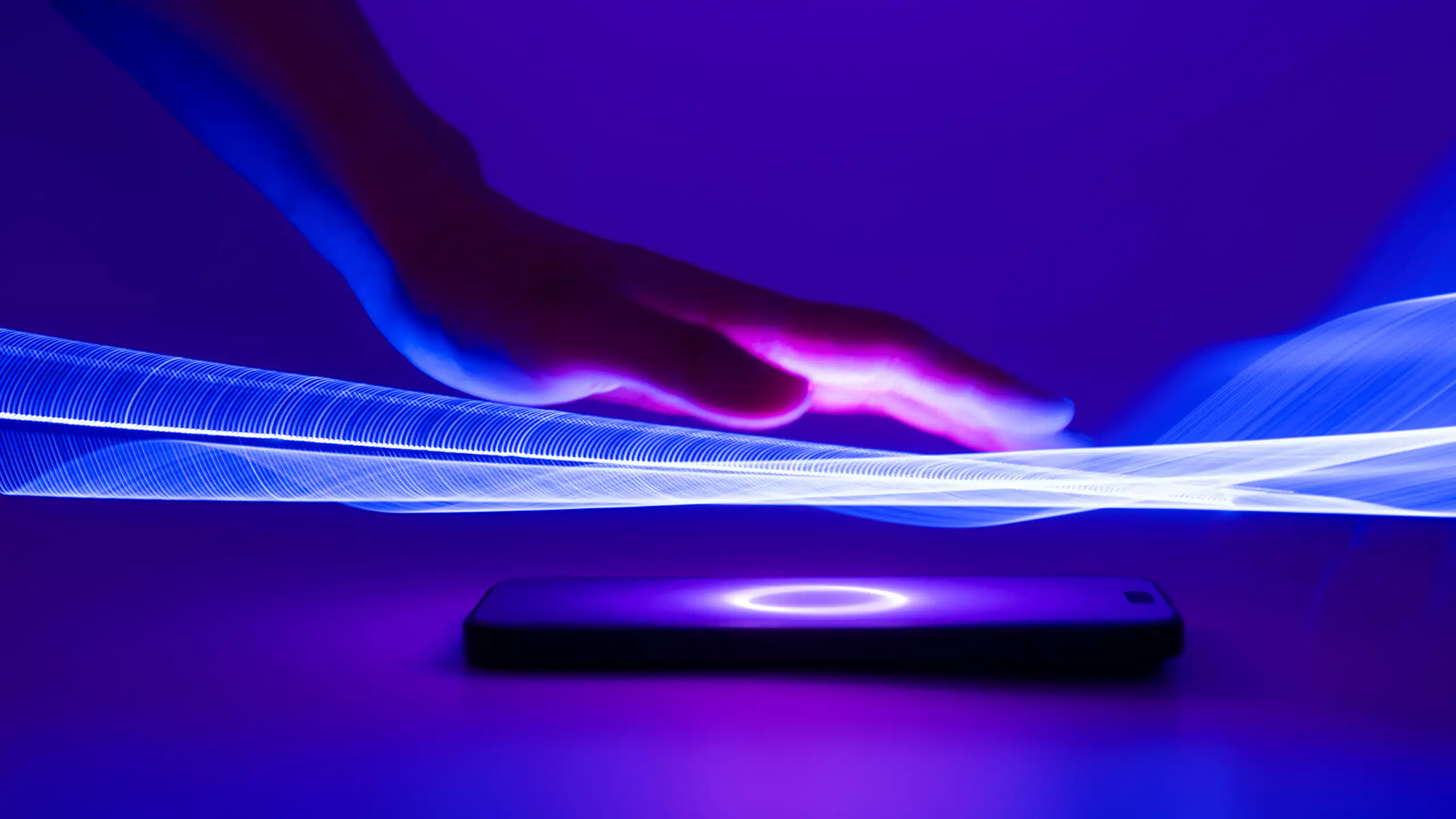 Digital illustration of a hand hovering over a glowing screen.