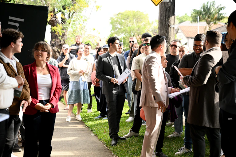 Potential home buyers attend a property auction