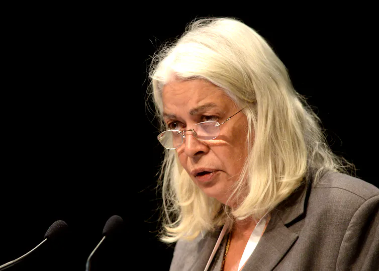 a stern white-haired older woman