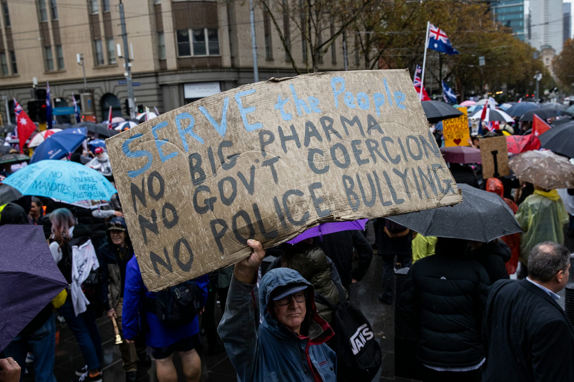 Protester holding banner during a 'Freedom Rally' in Melbourne, 2022