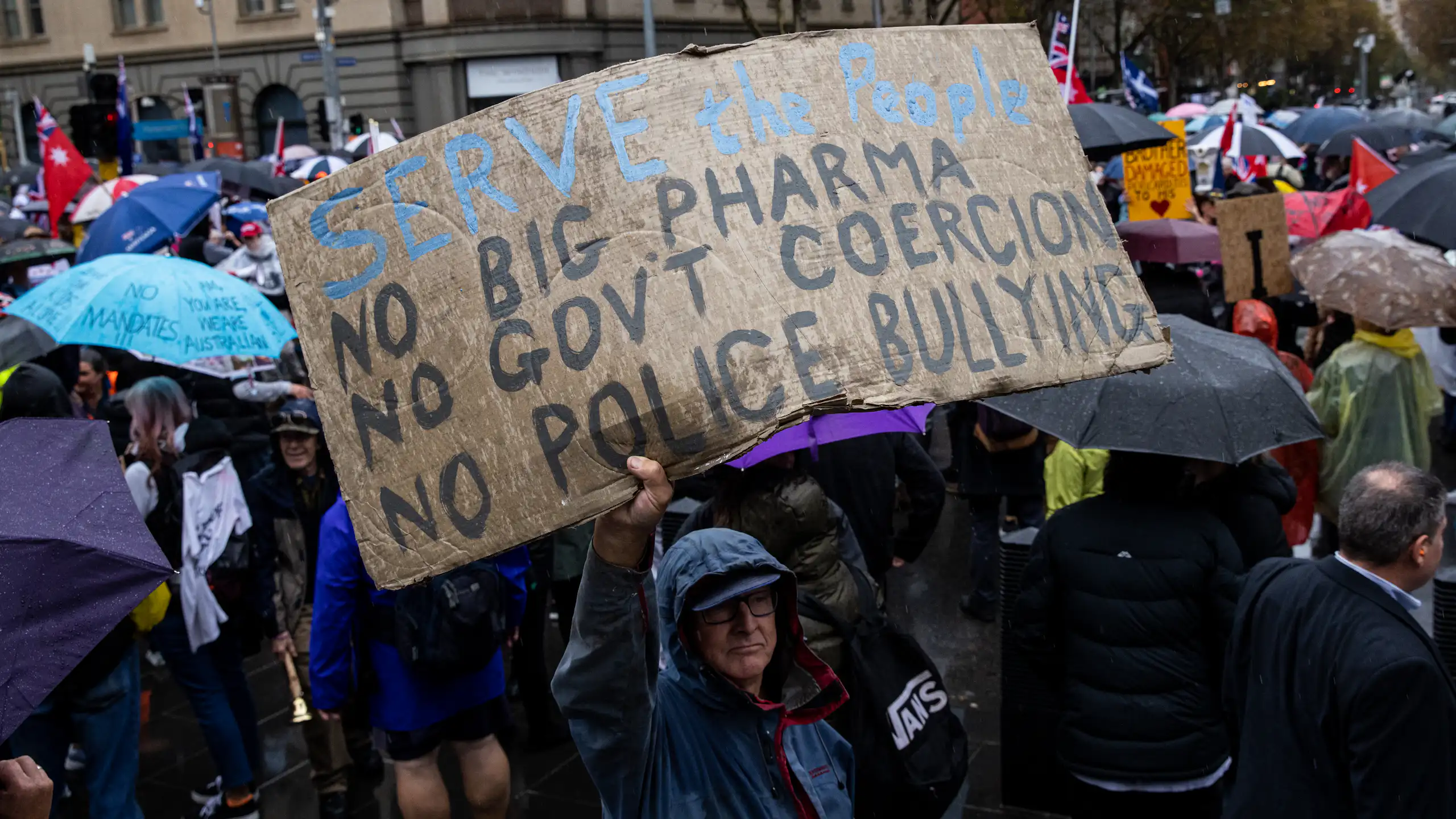 Protester holding banner during a 'Freedom Rally' in Melbourne, 2022