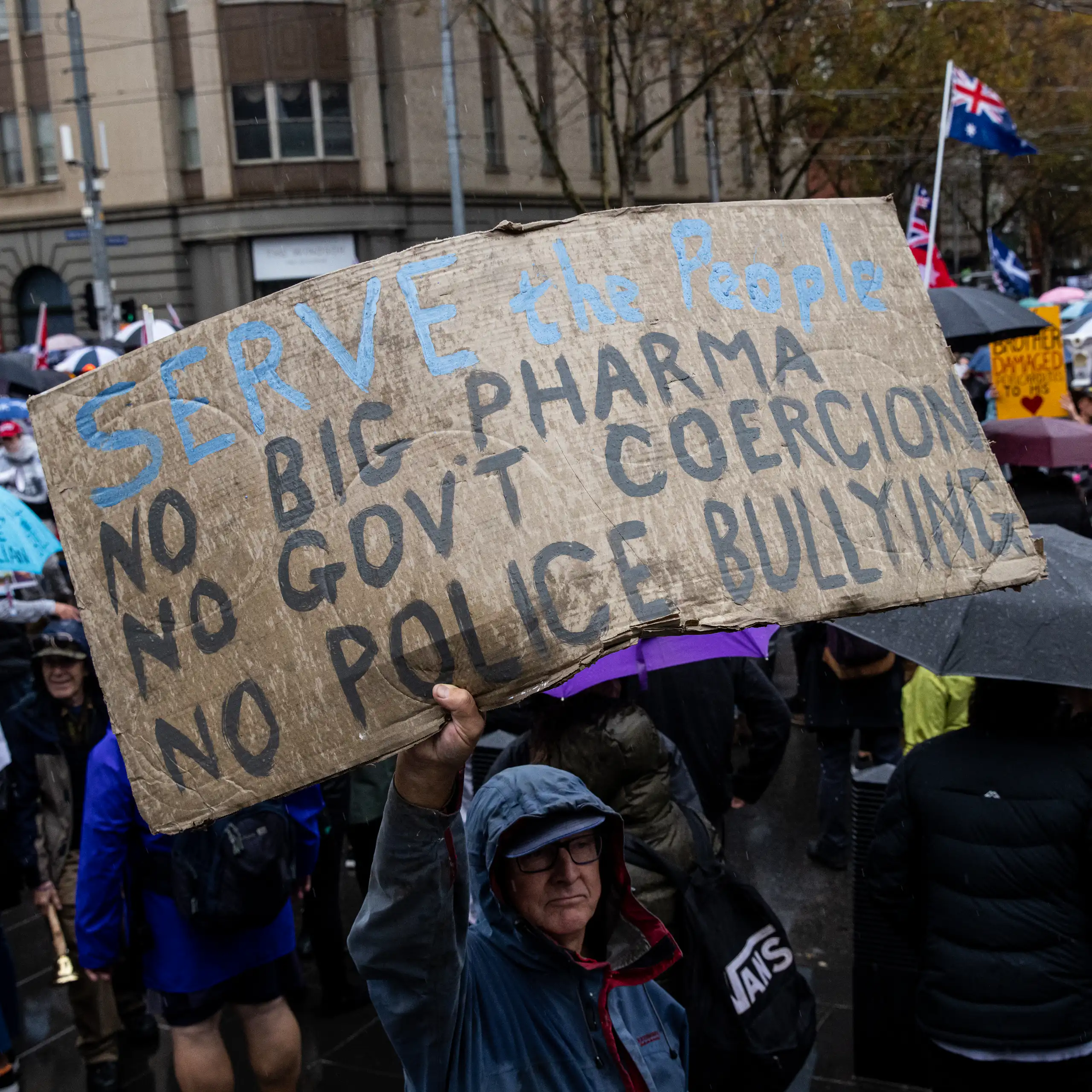 Protester holding banner during a 'Freedom Rally' in Melbourne, 2022