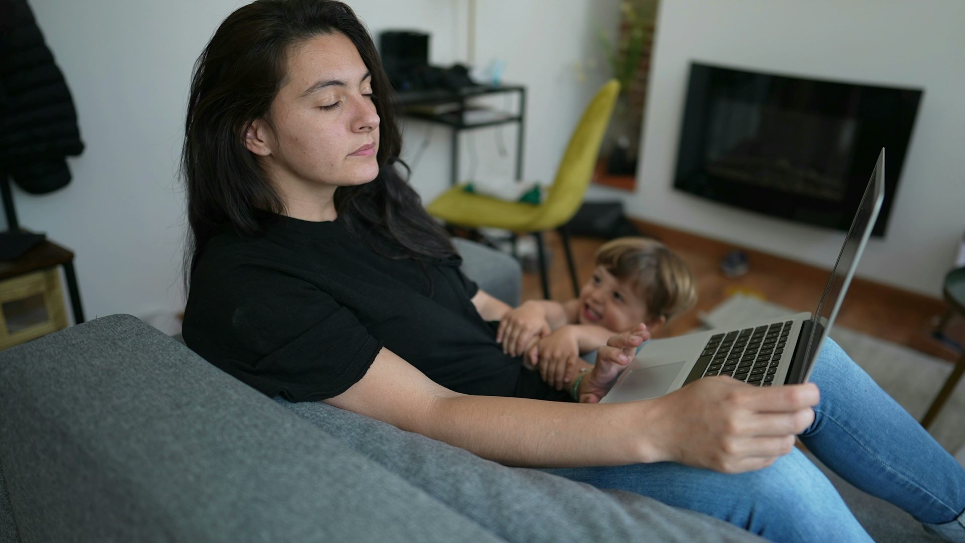 Mother interrupted by child while using laptop