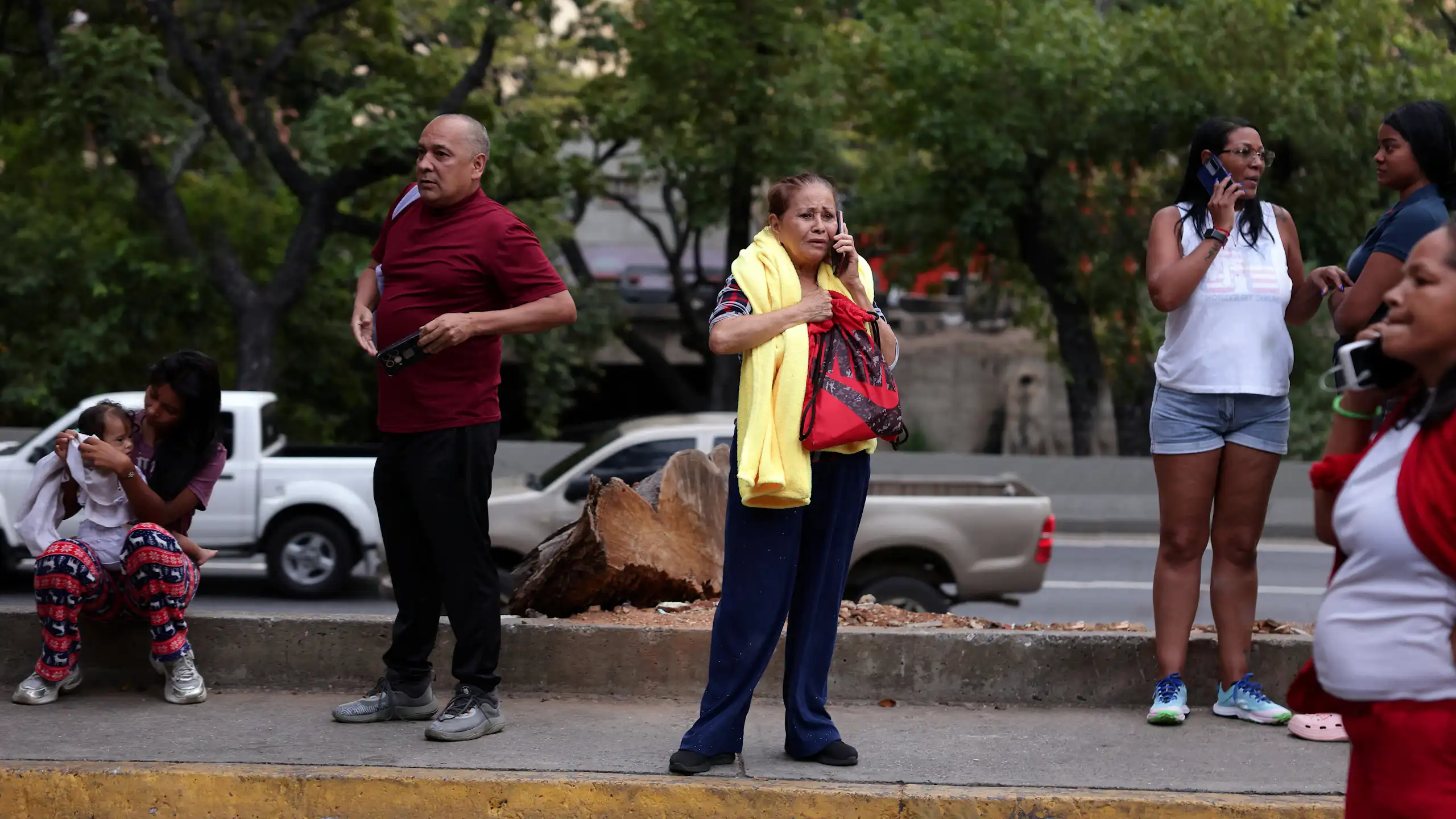 People speaking on the phone in a street.