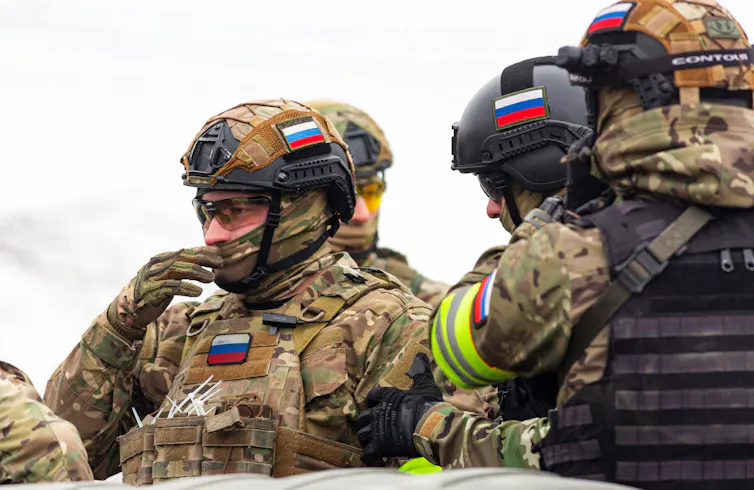 Russian Soldiers talking as they prepare for combat.