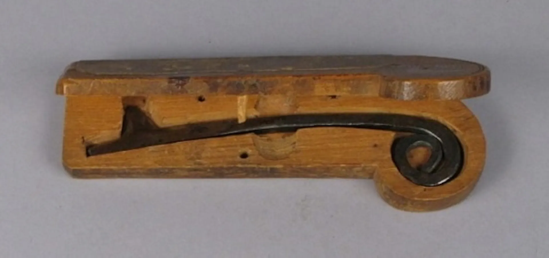 a metal tool nestled in a wooden holder