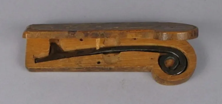 una herramienta de metal anidada en un soporte de madera