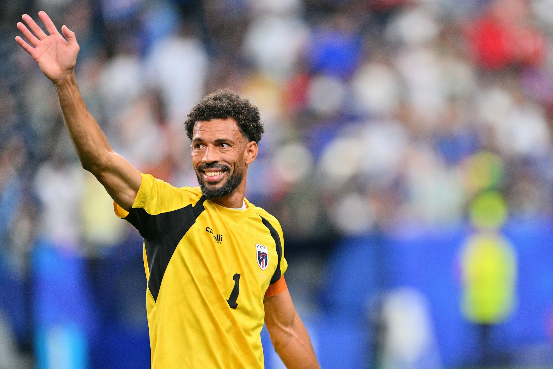 Cabo Verde's goalkeeper, Vozinha, waves to fans.