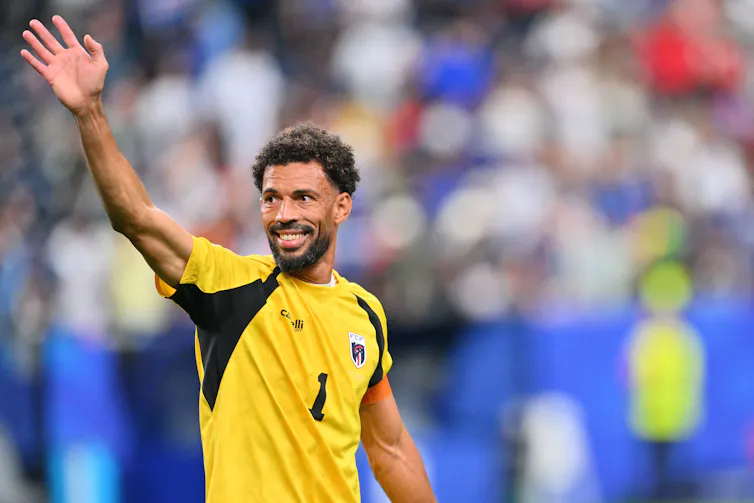 Cabo Verde's goalkeeper, Vozinha, waves to fans.