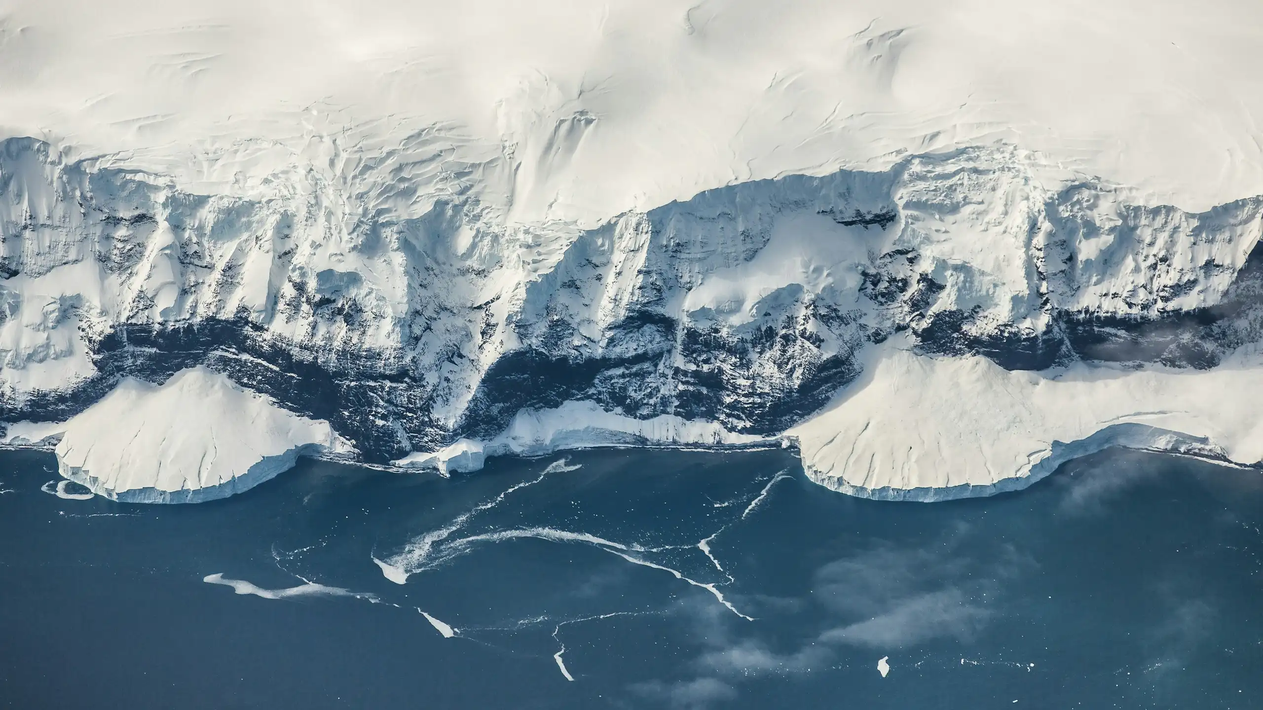 Antarctic ice meets the rocky coastline.