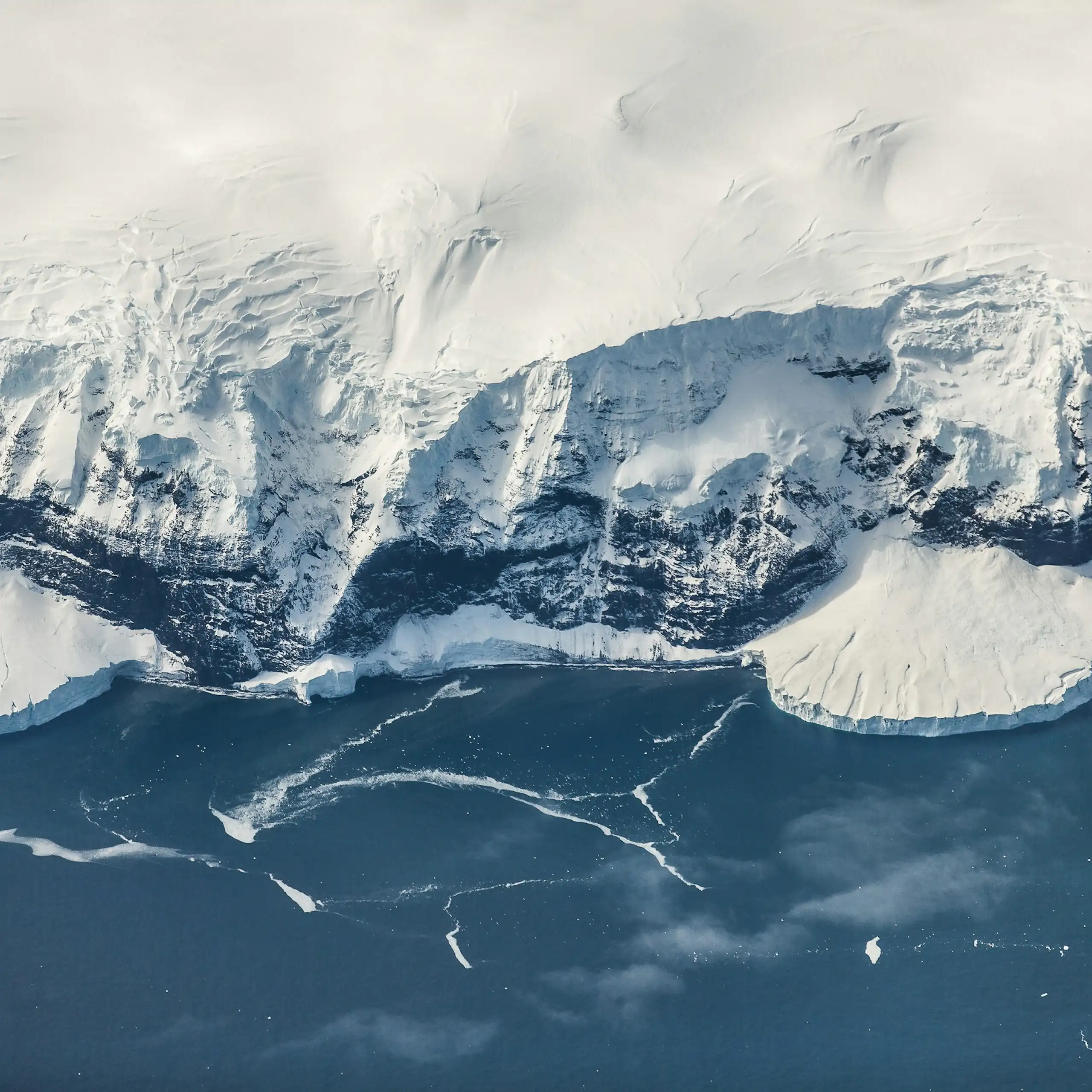 Antarctic ice meets the rocky coastline.
