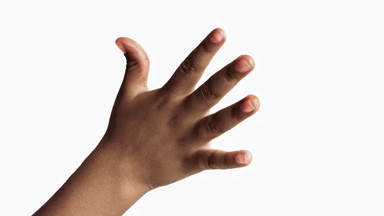 A young child's hand against a white background
