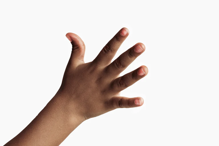 A young child's hand against a white background