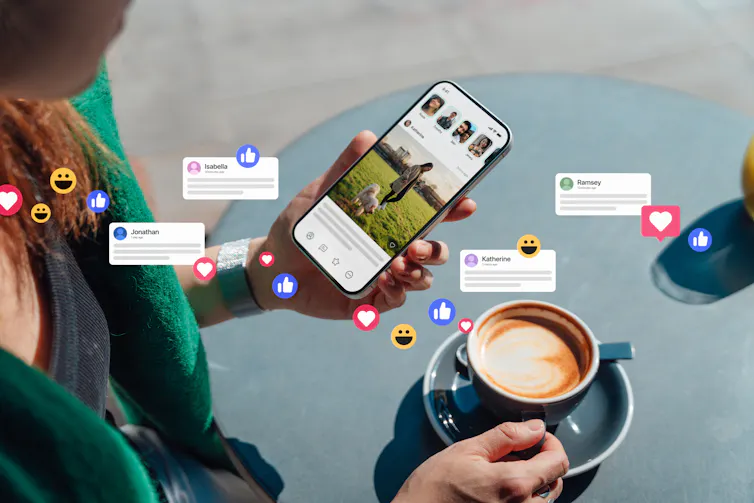 social media 'like' bubbles popping over woman holding phone above coffee