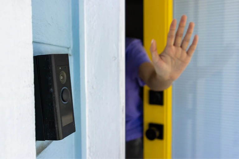 a hand in a 'halt' pose pokes out from a door