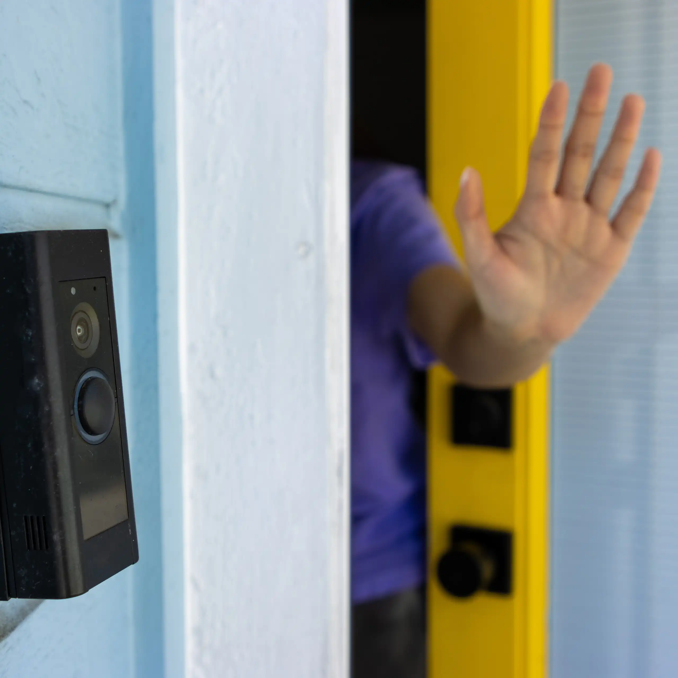 a hand in a 'halt' pose pokes out from a door
