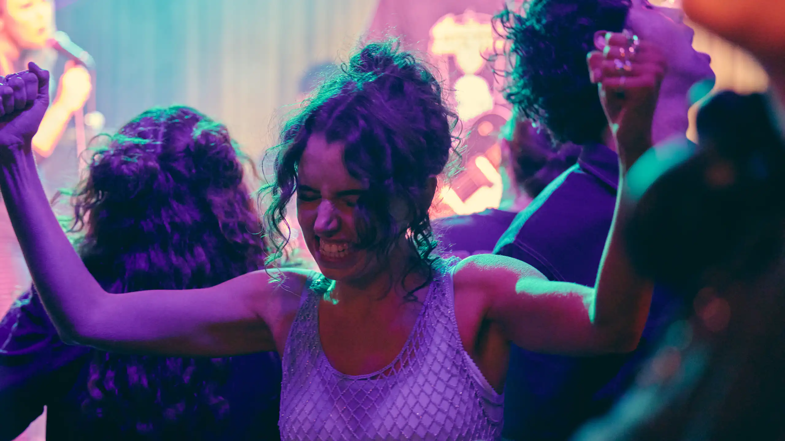 Production image: a young woman in a club.