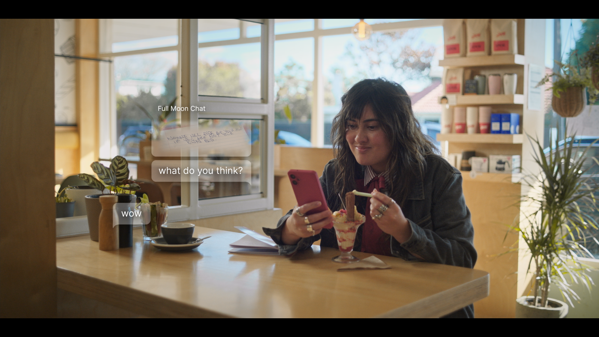 A woman in a diner on her phone.
