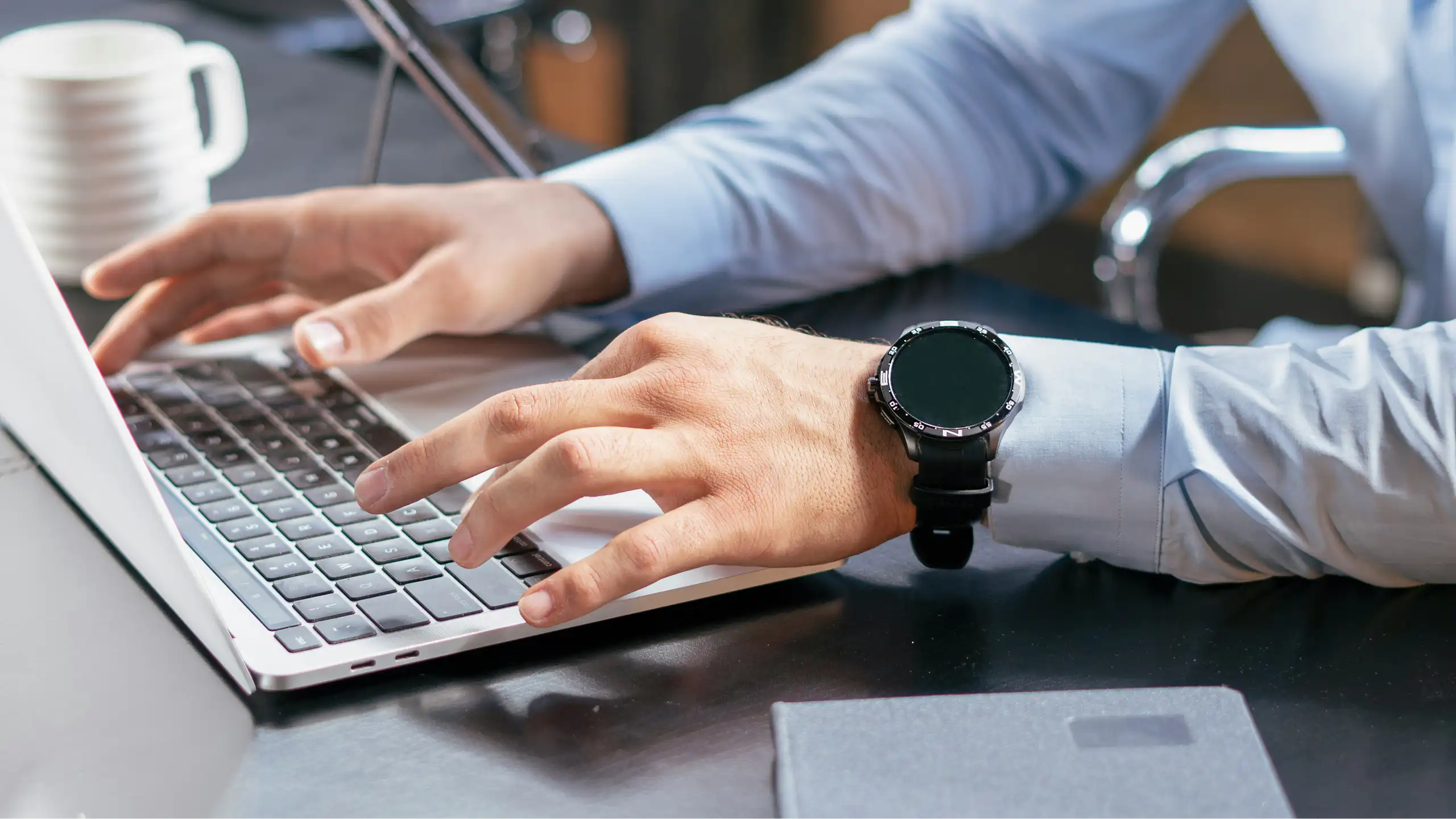 Close up of hands using a laptop