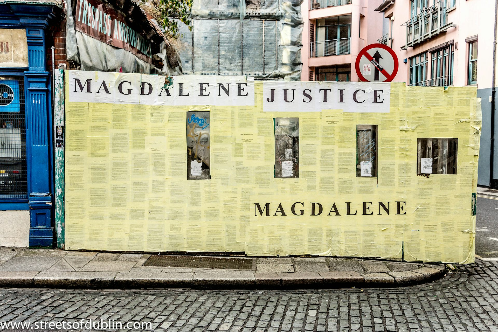 A colour photograph of activist posters on a wall in Ireland.