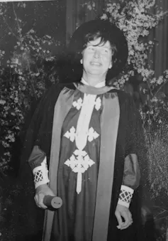 a woman in a graduation gown