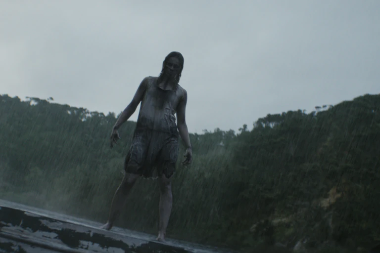 An uncanny female figure stood in the rain