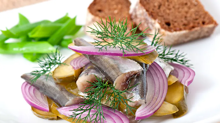 Herring salad with pickled cucumbers and onions.