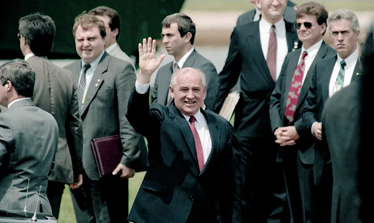 Mikhail Gorbachev waves as he prepares to leave a state visit in Washington.
