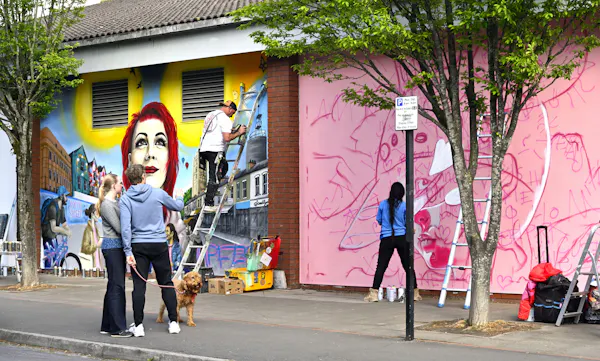 Couple standing in front of a mural in Bristoil