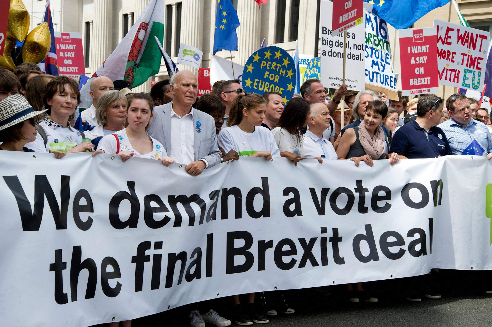 Gina Miller at the front of a campaign banner over Brexit