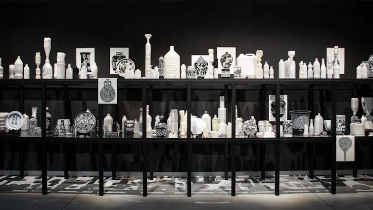 White plastic objects on black shelves.