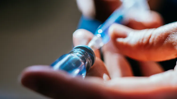Woman prepares a peptide injection