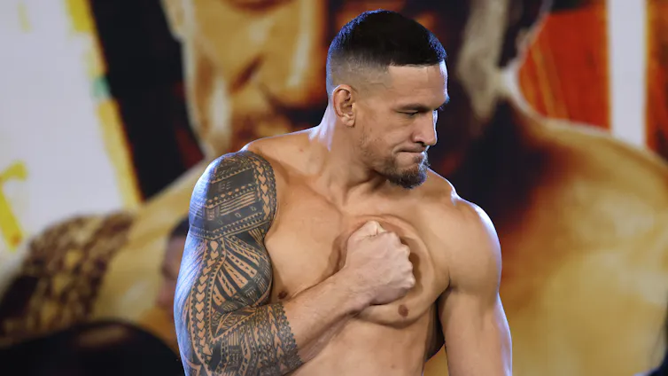 Former All Black Sonny Bill Williams holding a fist against his heart