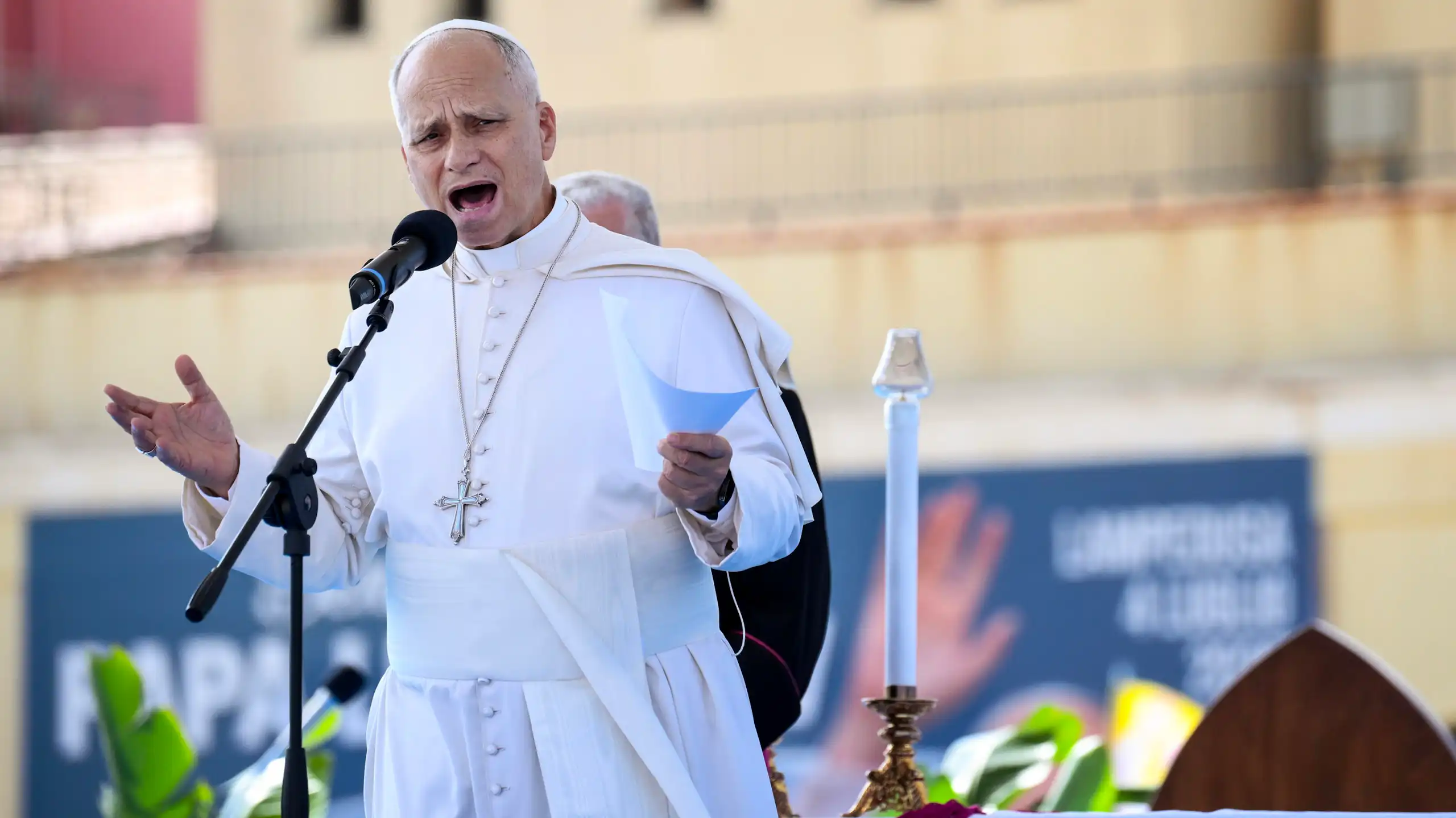 The pope speaking into a microphone