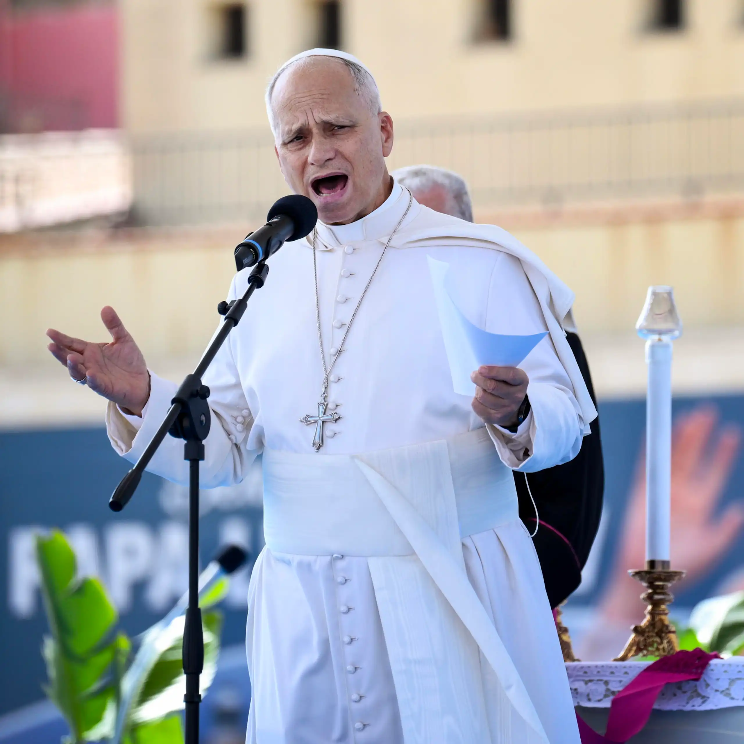 The pope speaking into a microphone