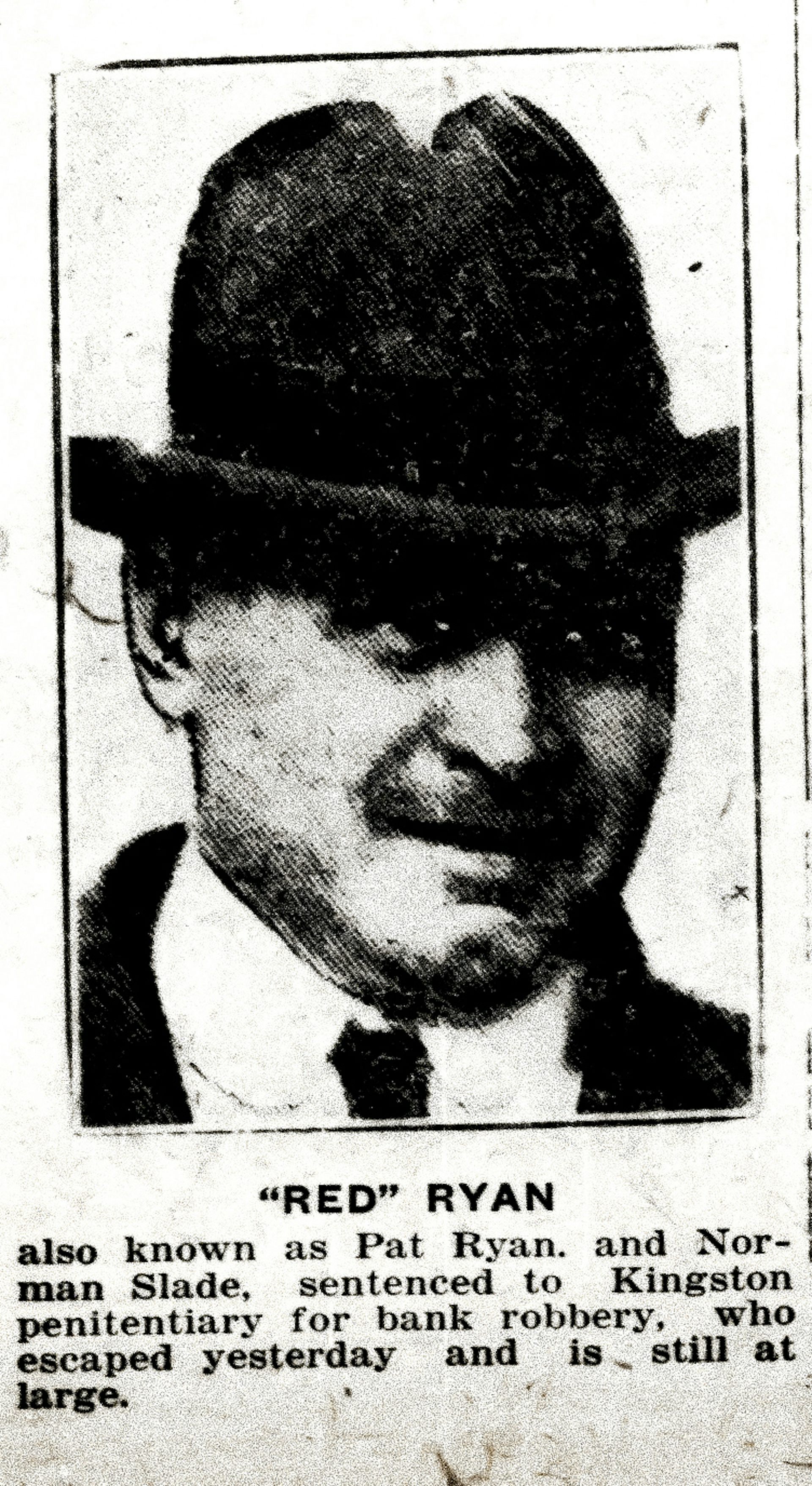 A man in a fedora and white shirt.