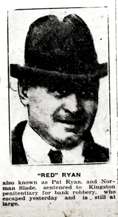 A man in a fedora and white shirt.