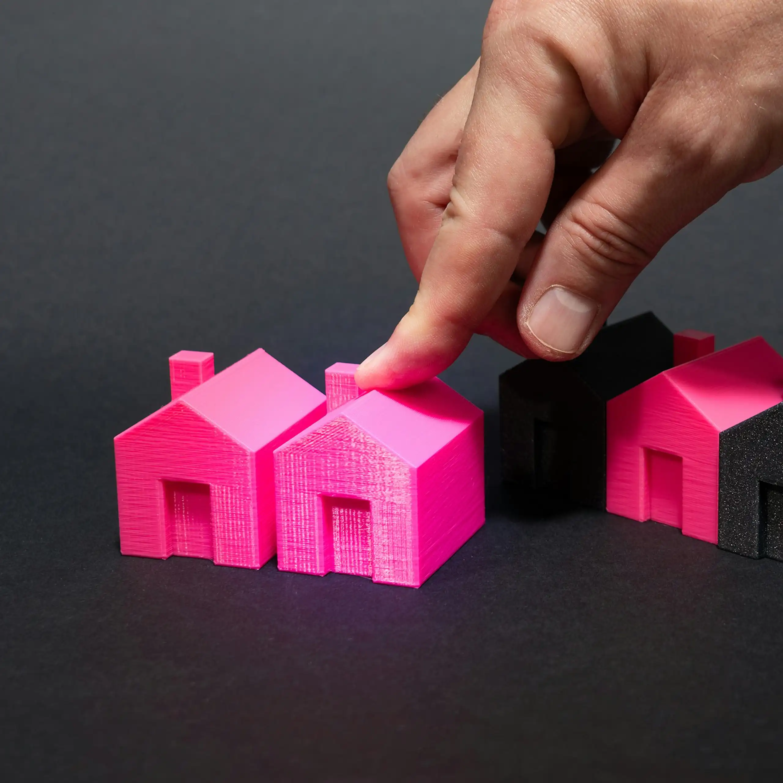 black and pink house figurines made of plastic