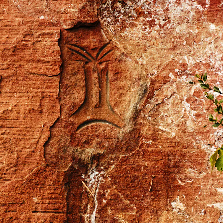 orange rock with old rock art painted on
