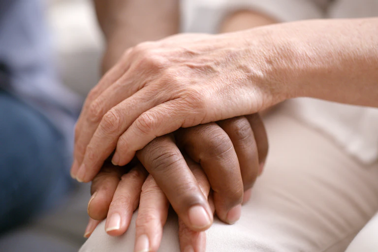 Three hands stacked on top and beneath one another.