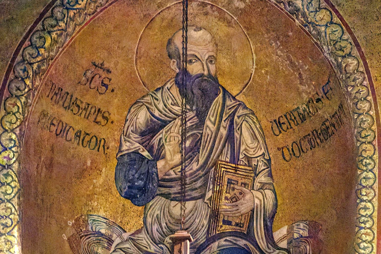 A mosaic of a man with a beard, set against a glittering gold background.