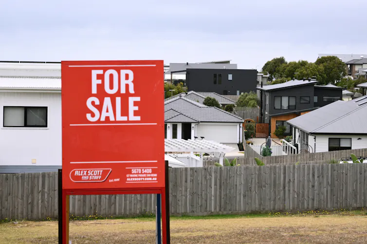A for sale sign in front of a property development