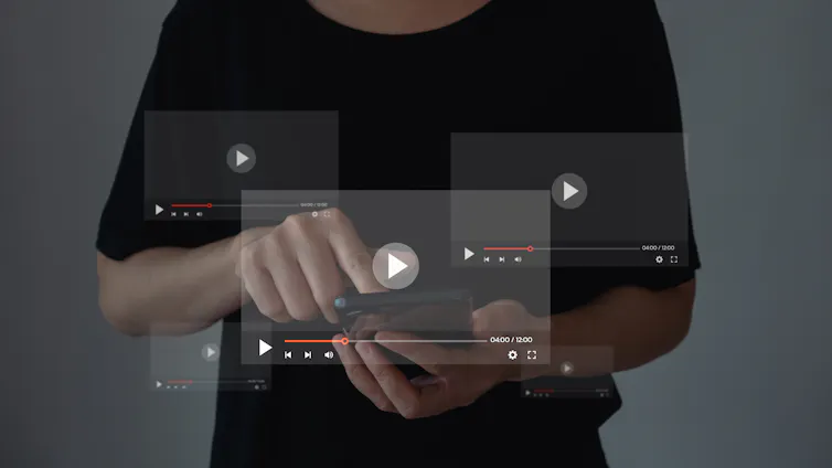A person in a black shirt is using a phone, with three media player screens superimposed over the top of the photo for visual effect.