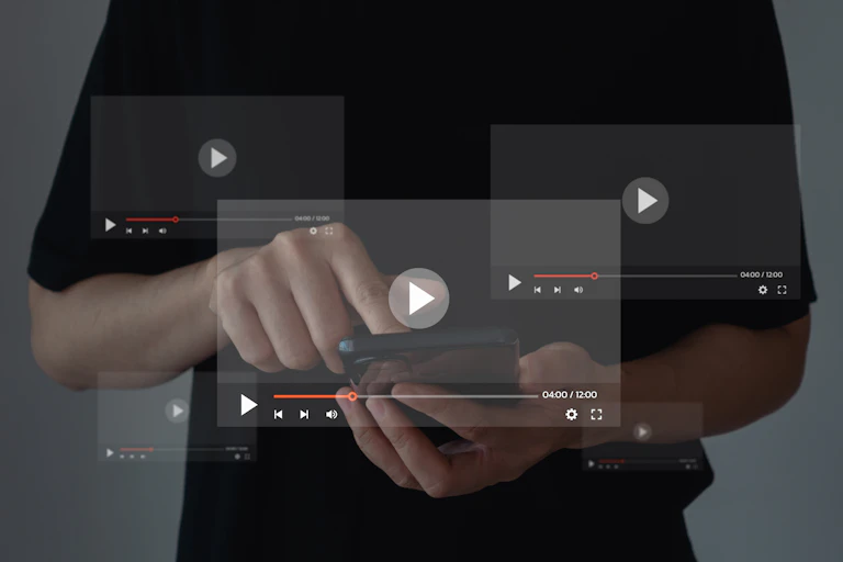 A person in a black shirt is using a phone, with three media player screens superimposed over the top of the photo for visual effect.